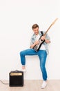 Young happy cool rocker playing on electric guitar Royalty Free Stock Photo