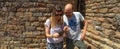 Young happy couple of alternative woman with sunglasses and bald man looking and pointing on the mobile phone new routes for Royalty Free Stock Photo