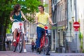 Young happy couple on bikes in old streets in Royalty Free Stock Photo