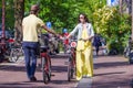 Young happy couple on bikes in old streets in Royalty Free Stock Photo