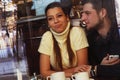 Young happy couple in cafe, view through a window, close-up Royalty Free Stock Photo