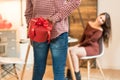 Young happy couple celebrating Valentine`s day with a gift