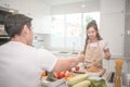 Young happy couple cooking together in the kitchen at home Royalty Free Stock Photo