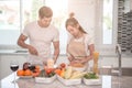 Young happy couple cooking together in the kitchen at home Royalty Free Stock Photo