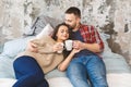 Young happy couple drinking coffee or tea in bed at the morning Royalty Free Stock Photo