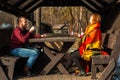 Young happy couple drinking tea   while resting in autumn forest Royalty Free Stock Photo
