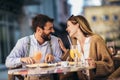 Happy couple eating pizza for lunch in a restaurant Royalty Free Stock Photo