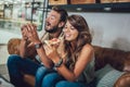 Young happy couple eating pizza in a restaurant