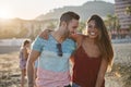 Young happy couple embracing each other on beach laughing Royalty Free Stock Photo