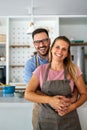 Young happy couple is enjoying and preparing healthy meal in their kitchen together Royalty Free Stock Photo