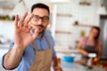 Young happy couple is enjoying and preparing healthy meal in their kitchen together Royalty Free Stock Photo