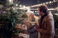 A young happy couple enjoying snowfall in the city. Christmas tree, love, relationship, Xmas, snow Royalty Free Stock Photo