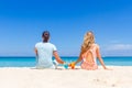 Young happy couple enjoying tropical cocktails on sand beach Royalty Free Stock Photo