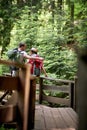 A young happy couple enjoying a walk on the forest path in the mountain. Trip, nature, hiking