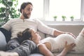 Young happy Couple expecting baby on sofa Royalty Free Stock Photo