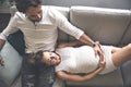 Young happy Couple expecting baby on sofa Royalty Free Stock Photo