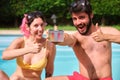 Young happy couple giving the ok to the ph and cl levels of their swimming pool. Royalty Free Stock Photo