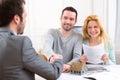 Young happy couple handshaking real estate agent after signing c Royalty Free Stock Photo