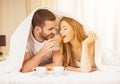 Young Happy Couple Have Breakfast in Bed at Home. Royalty Free Stock Photo