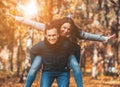 Young Happy Couple Have Fun in Park in Autumn. Royalty Free Stock Photo