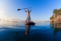 Young happy couple have fun on stand up paddleboard