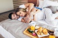 Happy couple having breakfast in luxury hotel room Royalty Free Stock Photo