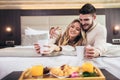 Happy couple having breakfast in luxury hotel room Royalty Free Stock Photo