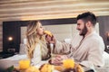 Happy couple having breakfast in luxury hotel room Royalty Free Stock Photo