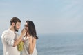 Young happy couple having date on seashore Royalty Free Stock Photo