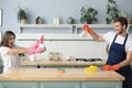 Young happy couple is having fun while doing cleaning at home Royalty Free Stock Photo