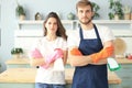 Young happy couple is having fun while doing cleaning at home Royalty Free Stock Photo