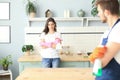 Young happy couple is having fun while doing cleaning at home Royalty Free Stock Photo