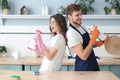 Young happy couple is having fun while doing cleaning at home Royalty Free Stock Photo