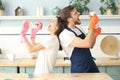 Young happy couple is having fun while doing cleaning and singing at home Royalty Free Stock Photo