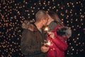 Young happy couple having fun outdoors in winter before Christmas with sparklers in hands Royalty Free Stock Photo