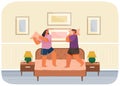 Young happy couple having pillow battle, man and woman wearing pajamas enjoying time together