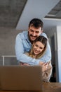 Young happy couple having video call online, conversation with relatives, communicating with friends