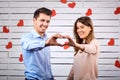 Young happy couple with heart in hands onbackground Royalty Free Stock Photo