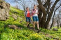 Young Happy Couple Hiking with Backpacks on the Beautiful Rocky Trail at Sunny Evening. Family Travel and Adventure. Royalty Free Stock Photo
