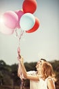 Young happy couple holding colorful ballons and smiling Royalty Free Stock Photo