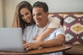 Young happy couple at home boy and girl surfing the web together smiling and enjoying internet search connection. Modern people in Royalty Free Stock Photo