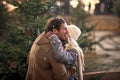 A young happy couple in a hug on a snowy weather in the city. Christmas tree, love, relationship, Xmas, snow Royalty Free Stock Photo