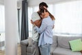 Young happy couple hugging and kissing after they realize that they will have a baby. Pregnant woman hugging her man holding posit