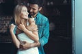 Young happy couple hugging and looking at each other in the interior of a new kitchen, happiness in a new home. Royalty Free Stock Photo