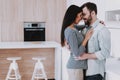 Young Happy Couple Hugging in Modern Kitchen. Royalty Free Stock Photo