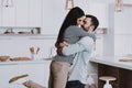 Young Happy Couple Hugging in Modern Kitchen. Royalty Free Stock Photo