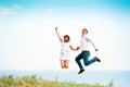 Young happy couple jumping on the beach Royalty Free Stock Photo