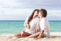 Young happy couple kissing at tropical beach. honeymoon Royalty Free Stock Photo