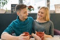 Young happy couple in love in cafe, young man and woman together smile hugging drink coffee tea