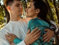 Young happy couple in love of different nationality hugging and kissing near river. Asian woman and european man. Royalty Free Stock Photo